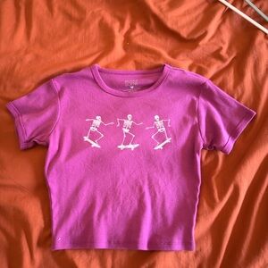 Pink baby tee with skeletons skate boarding M